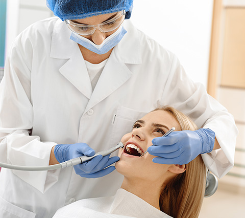 Dentista en Las Condes aplicando tratamiento a paciente